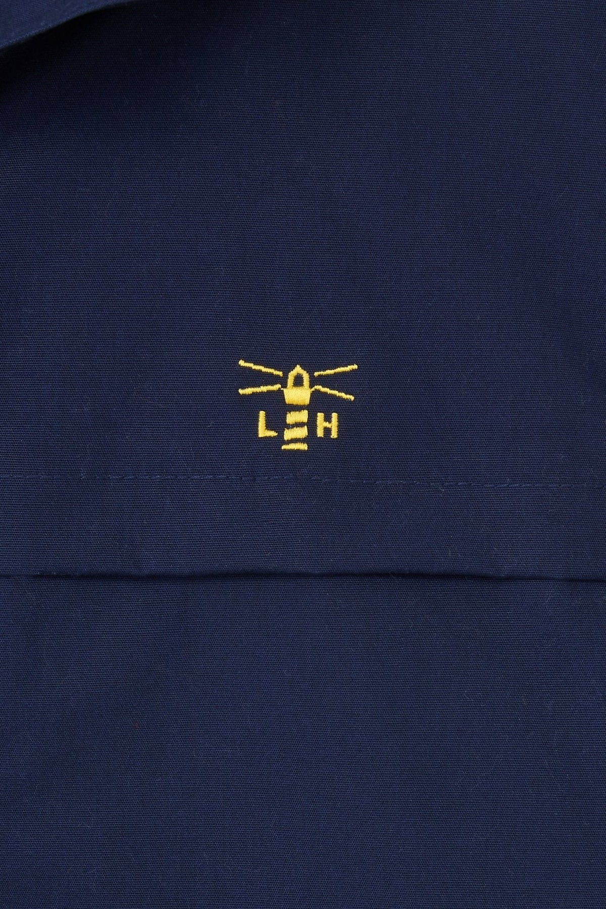 Lighthouse womens navy hooded Alicia waterproof rain jacket with yellow logo.