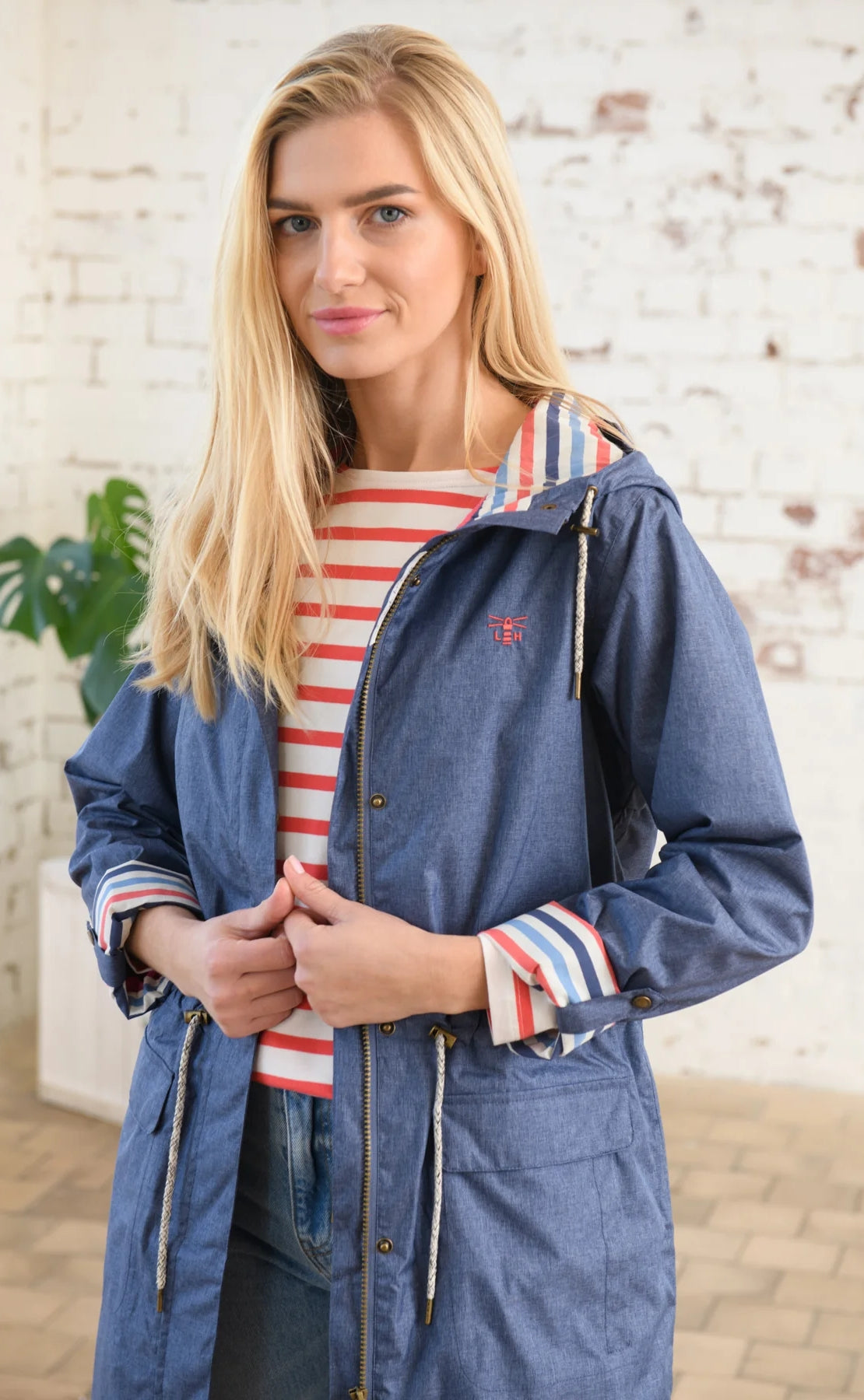 Lighthouse women's Alice waterproof rain coat in Denim Blue with drawstring waist.