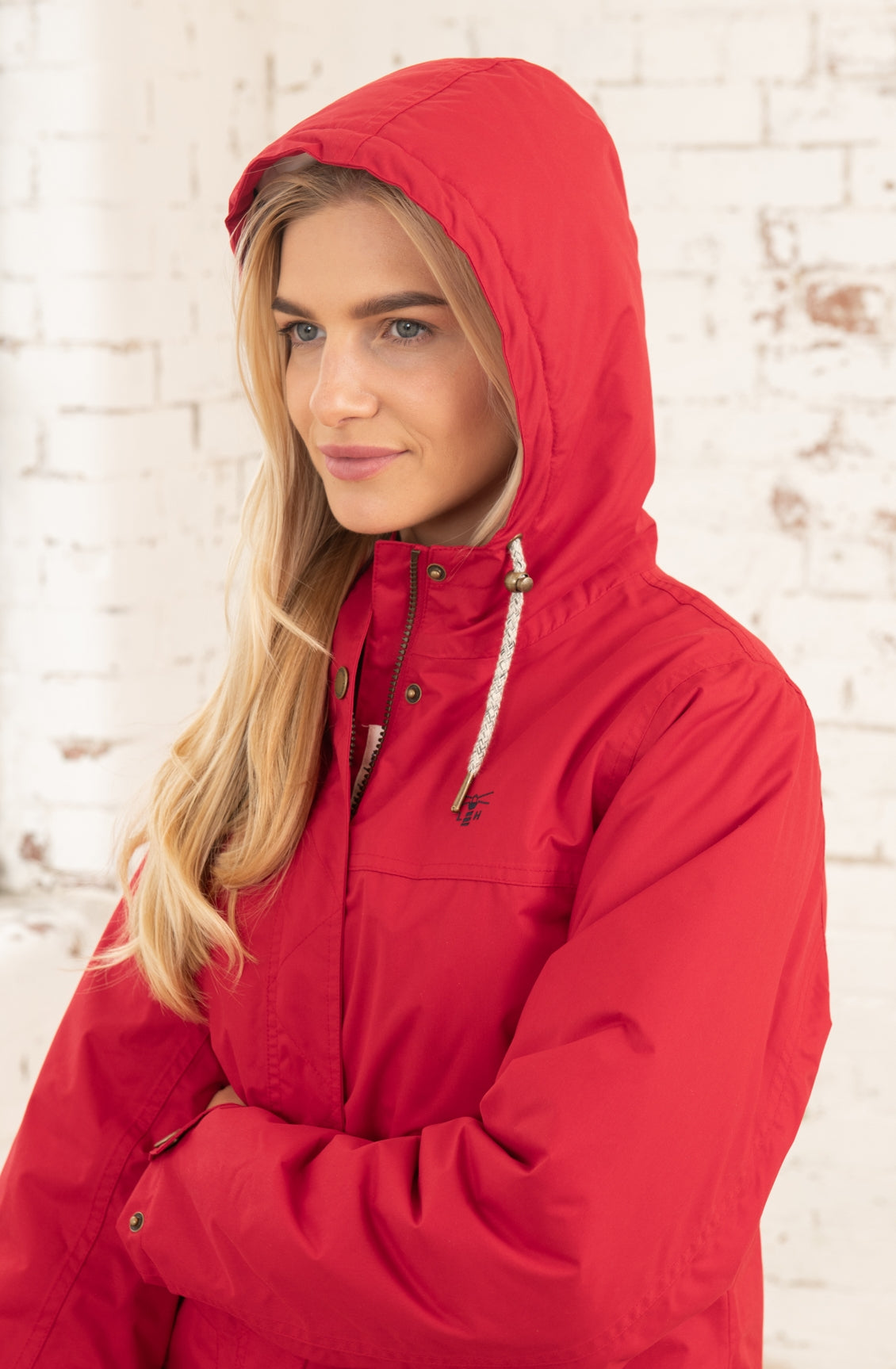 Women's hooded waterproof Eva Long rain coat from Lighthouse in Red.