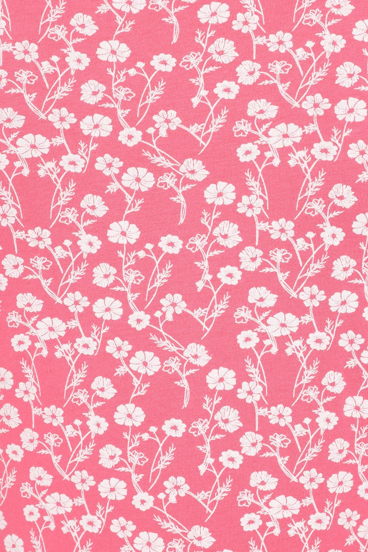 Close-up of Mudd and Water womens pink floral top fabric with white flower pattern