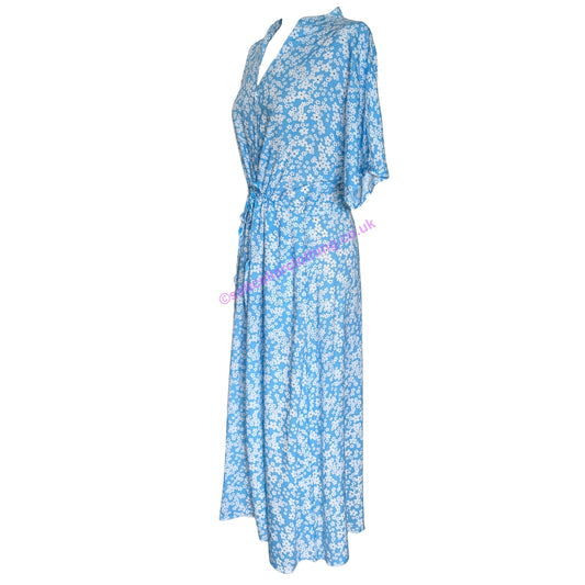 Side view of a womens Mudd & Water short sleeve blue floral Alyssa wrap dress on a white background
