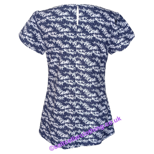Back view of a womens Mudd & Water short sleeve Calla Top in navy with a white dot print