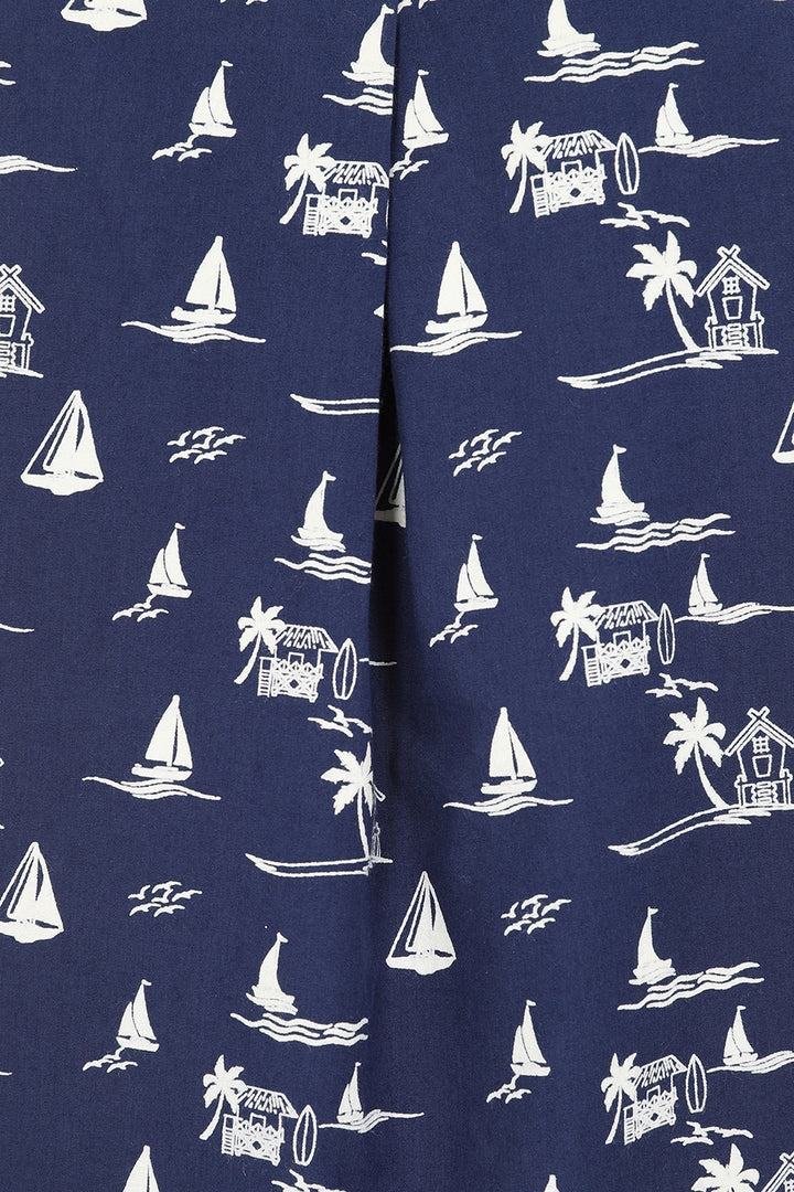 Closeup of the front pleat of a womens Mudd & Water Sunrise Blouse fabric in navy with a tropical nautical pattern