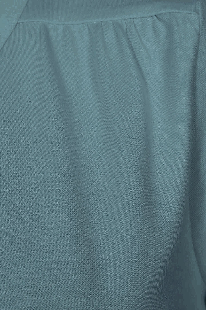 Close-up of gathered fabric on the shoulder of a womens Mudd & Water 'Aqua' tee in Teal.