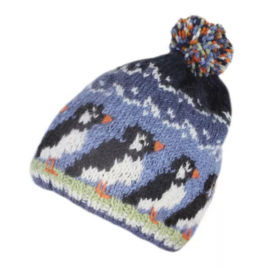 Knitted Pachamama beanie with puffin design and colourful pom-pom on a white background