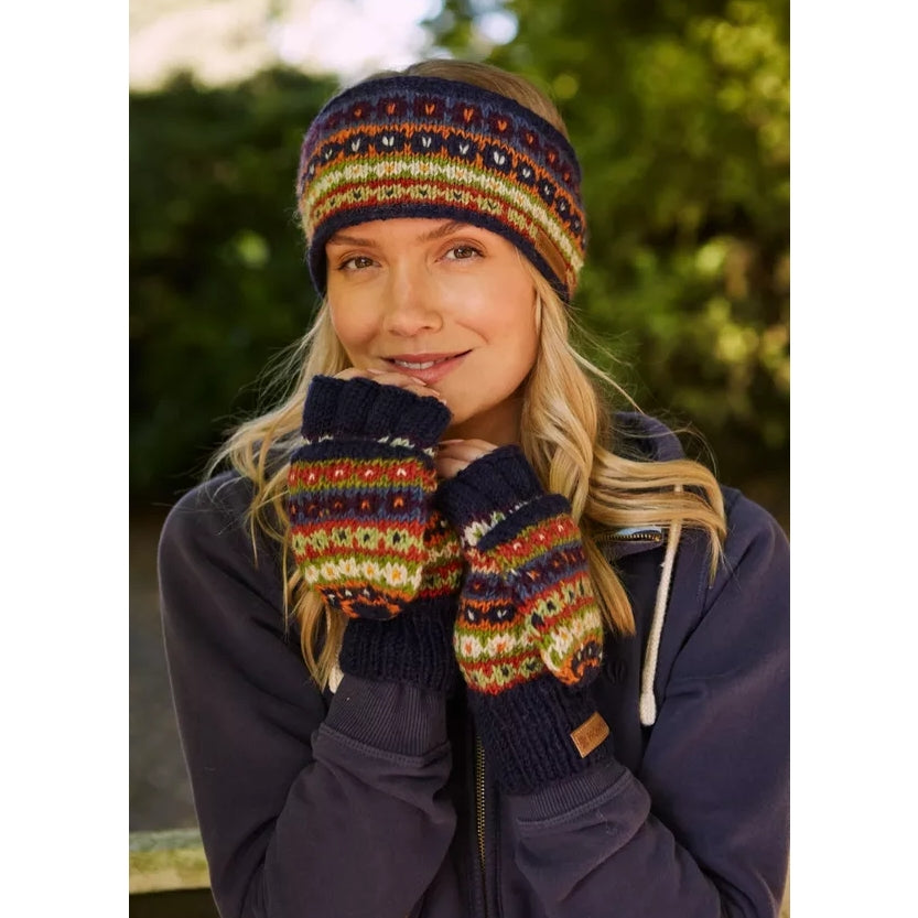 Woman wearing a pair of Pachamama Colorado fingerless glove mitts outdoors