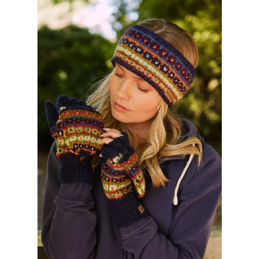 Woman wearing colourful Pachamama Colorado fingerless gloves outdoors.