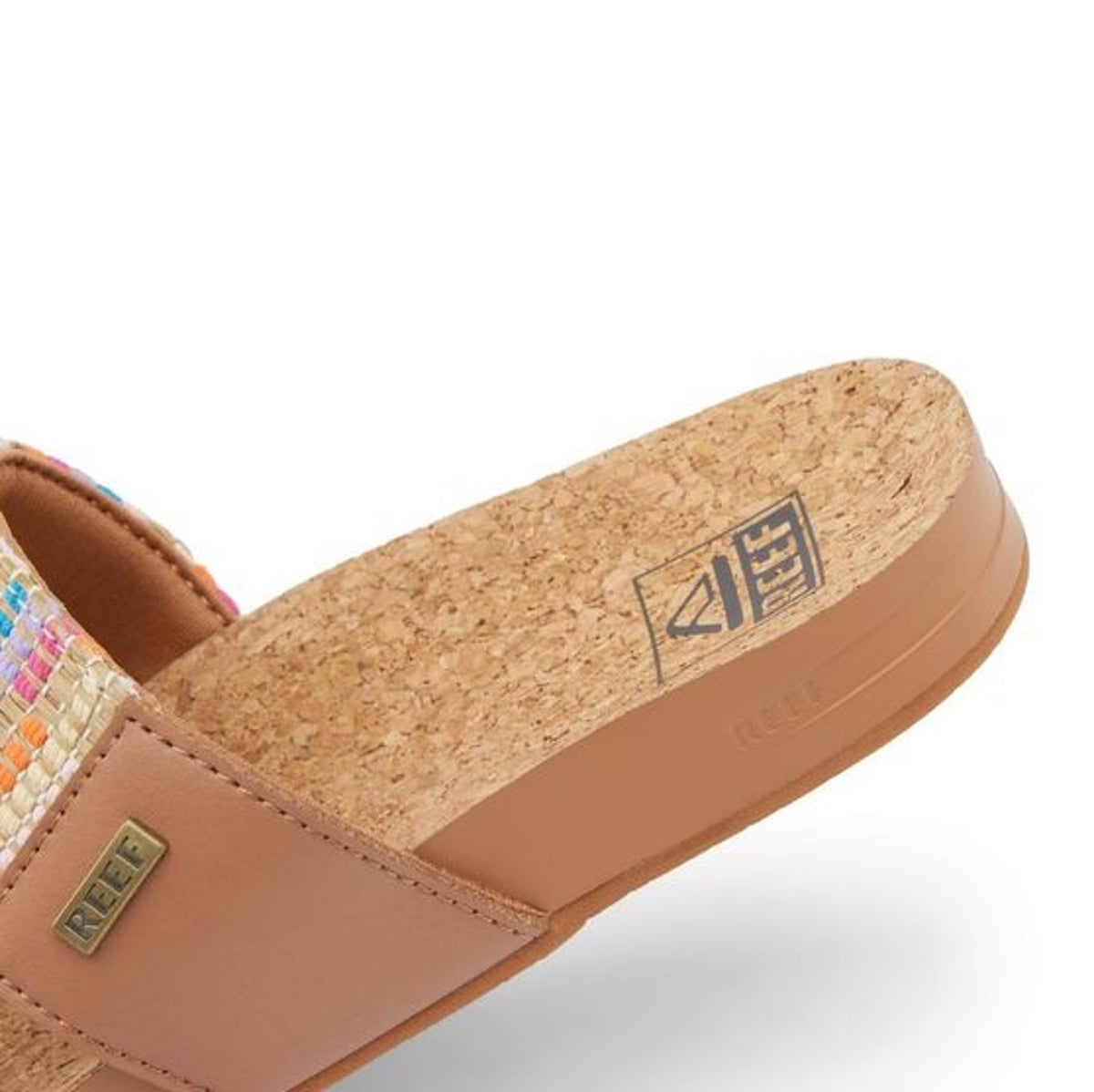 Reef womens cushion sandals with cork footbed and tan leather strap featuring colorful woven detail