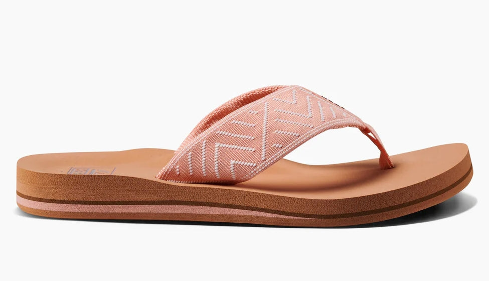 Reef womens peach flip flops with cushioned footbed and textured fabric straps for comfort and style