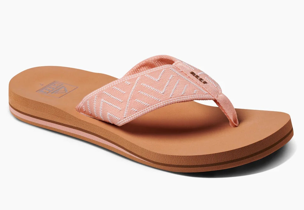 Front view of Reef womens peach flip flops with cushioned sole and patterned fabric straps for casual wear
