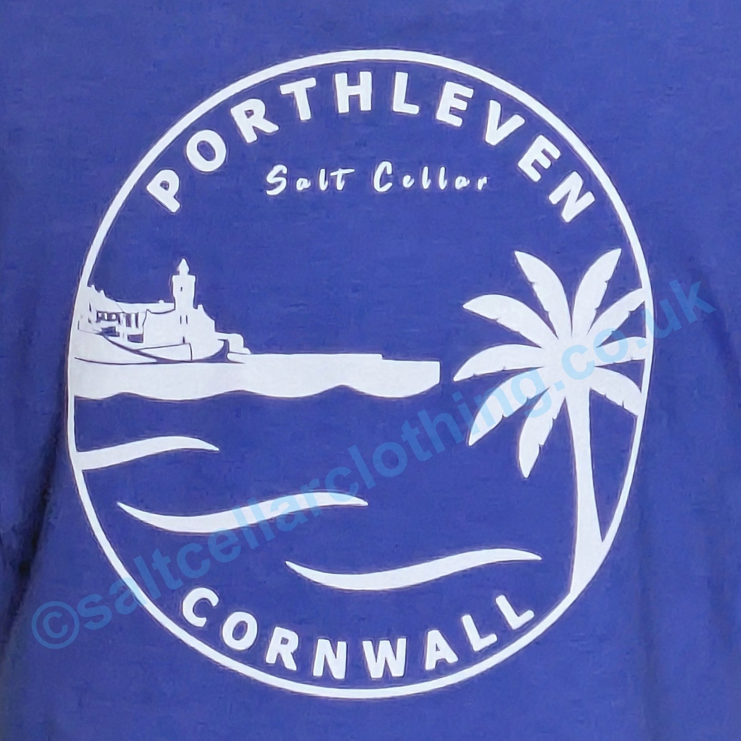 Blue kids t-shirt with white graphic of Porthleven, Cornwall featuring a harbour, clocktower and palm tree.