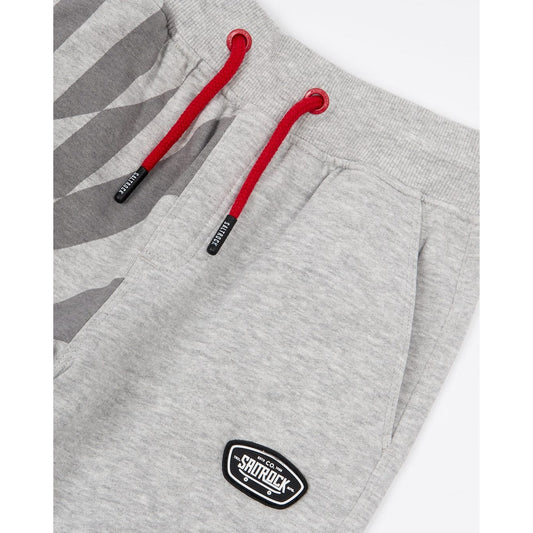 Close-up view of the drawcord waist on a pair of kids Saltrock Rip It jogger sweat trousers in grey with a geometric print on one leg