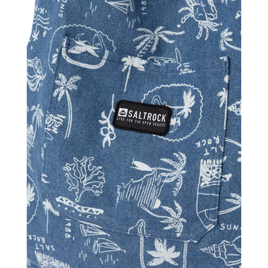 Close-up view of the front pocket with logo patch on a Saltrock Island Life shopper bag in denim blue with a white tropical seaside print.