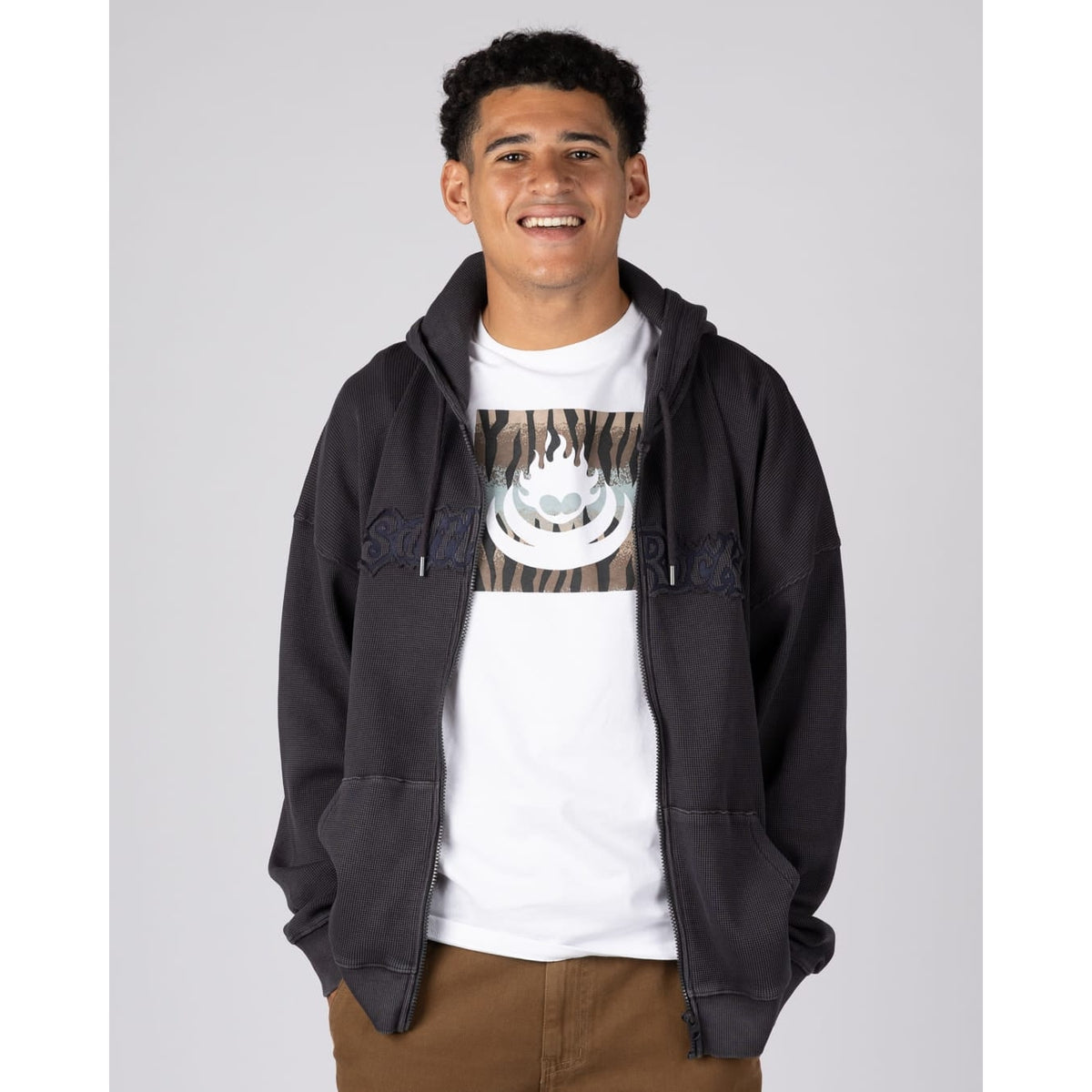 Front view of a man wearing a Saltrock Heritage Logo oversized full zip hoodie unzipped in Dark Grey with a waffle texture.