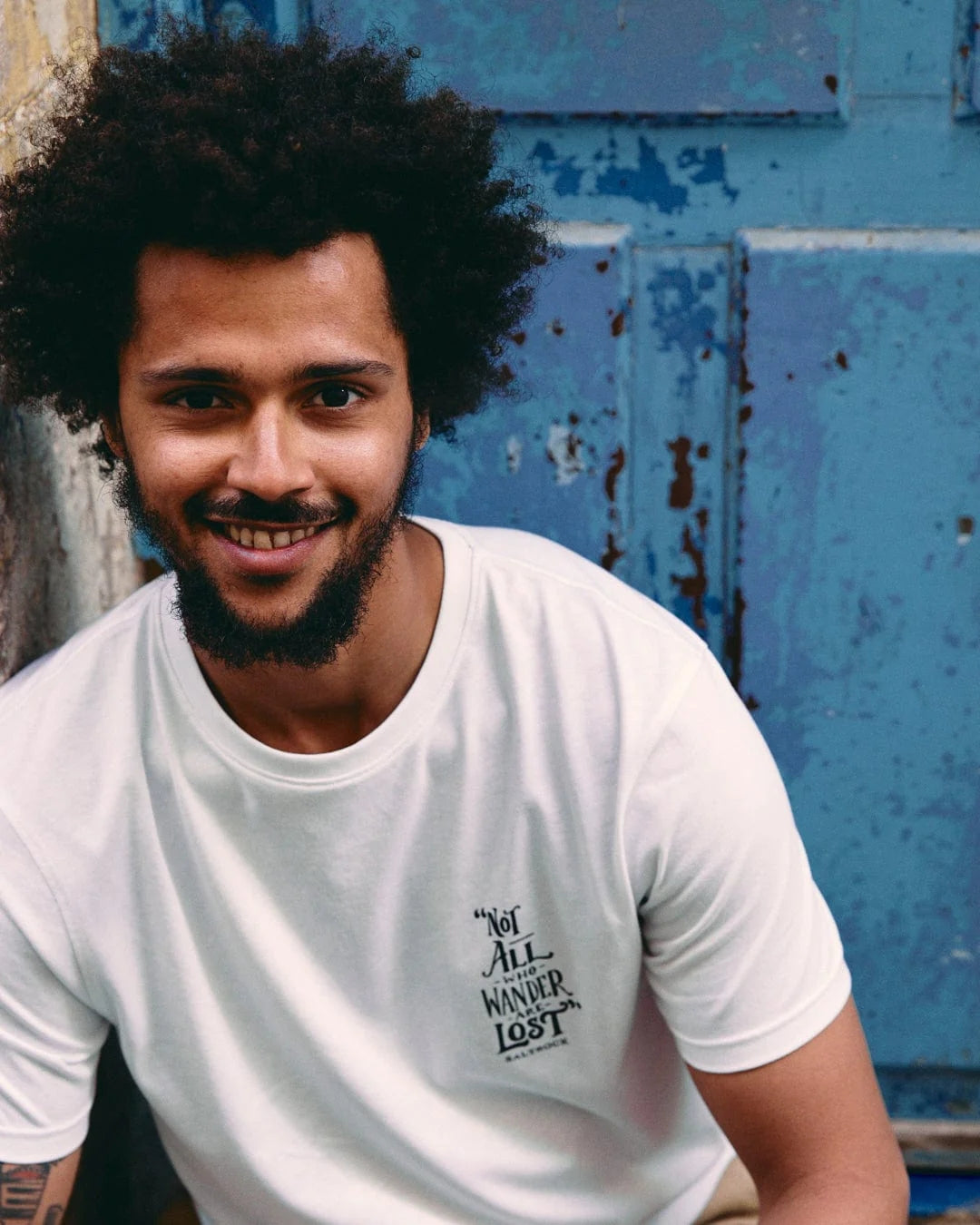 Man wearing Saltrock mens lost ships tee white casual t-shirt with small black text design on chest