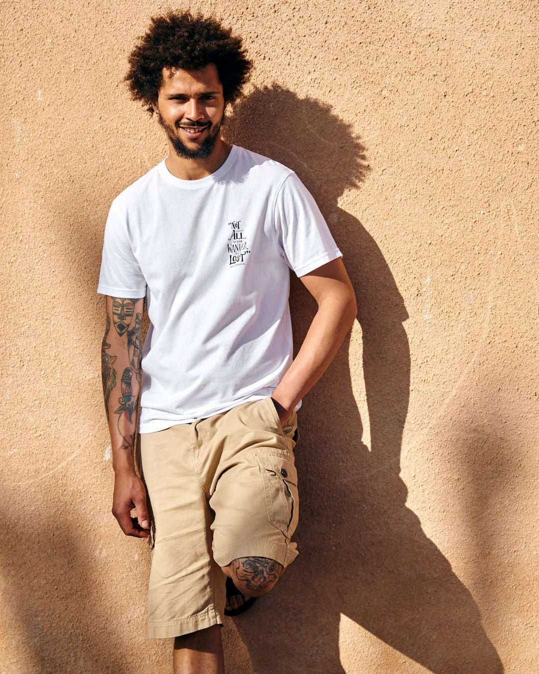 Man wearing Saltrock mens lost ships tee in white paired with beige cargo shorts outdoors
