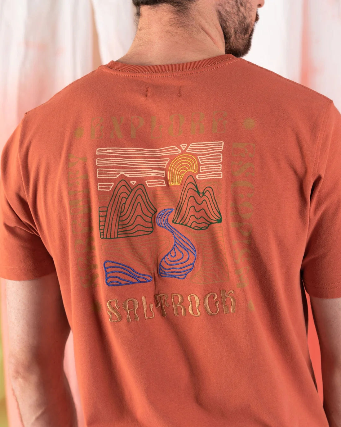 Saltrock mens t-shirt orange featuring graphic design of mountains and river on the back
