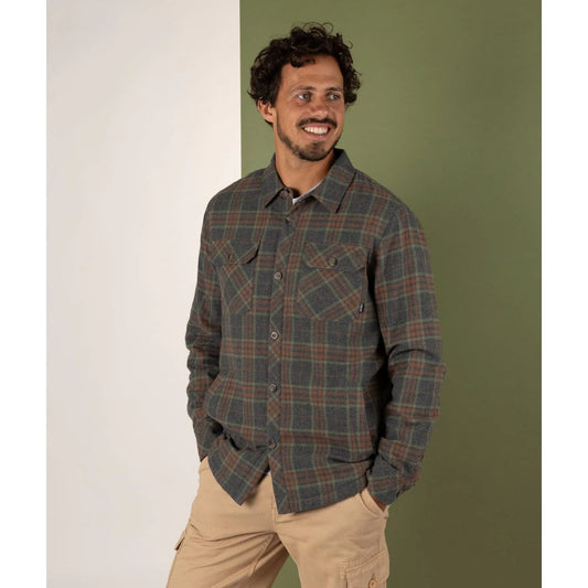 Man wearing a Saltrock Woody grey check shirt against a green and white background