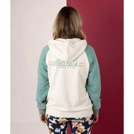 Back view of a woman wearing a Links contrast cream and light blue zip hoodie with 'Saltrock' branding on the back against a red and white background