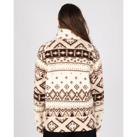 Back view of a woman wearing a Saltrock 1/4 zip Skylar fleece in cream with a brown geometric pattern