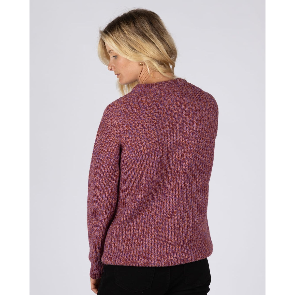 Back view of a woman wearing a Saltrock Lucy crew neck longline knitted jumper in purple.