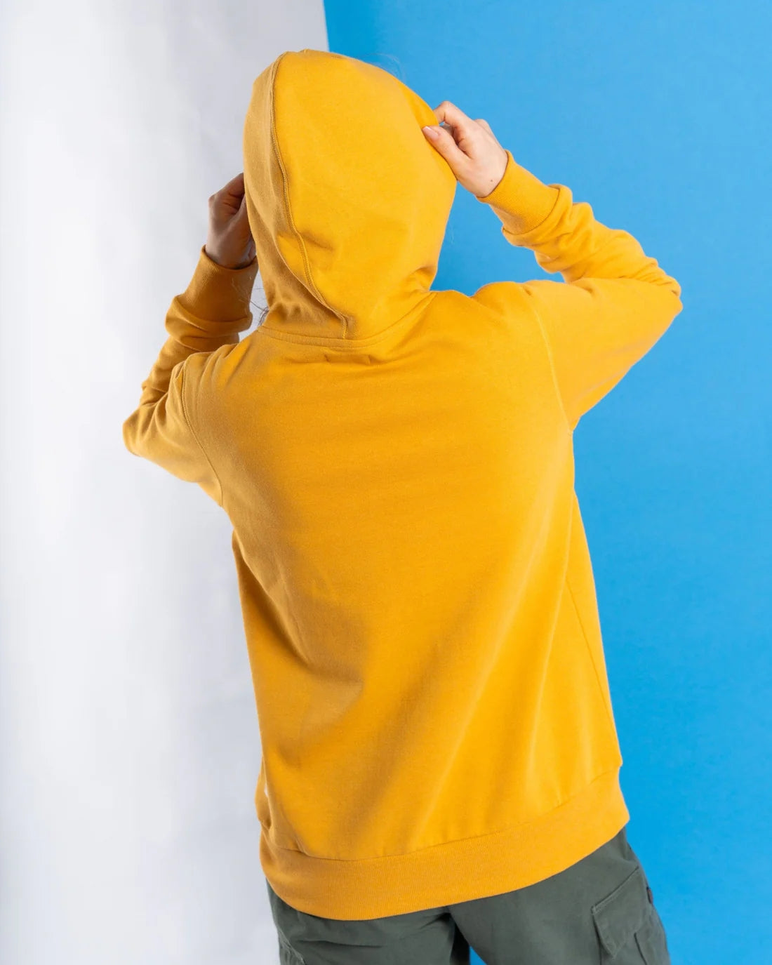 Womens Gold Yellow Hoodie Saltrock shown from back with hood up and hands adjusting hood