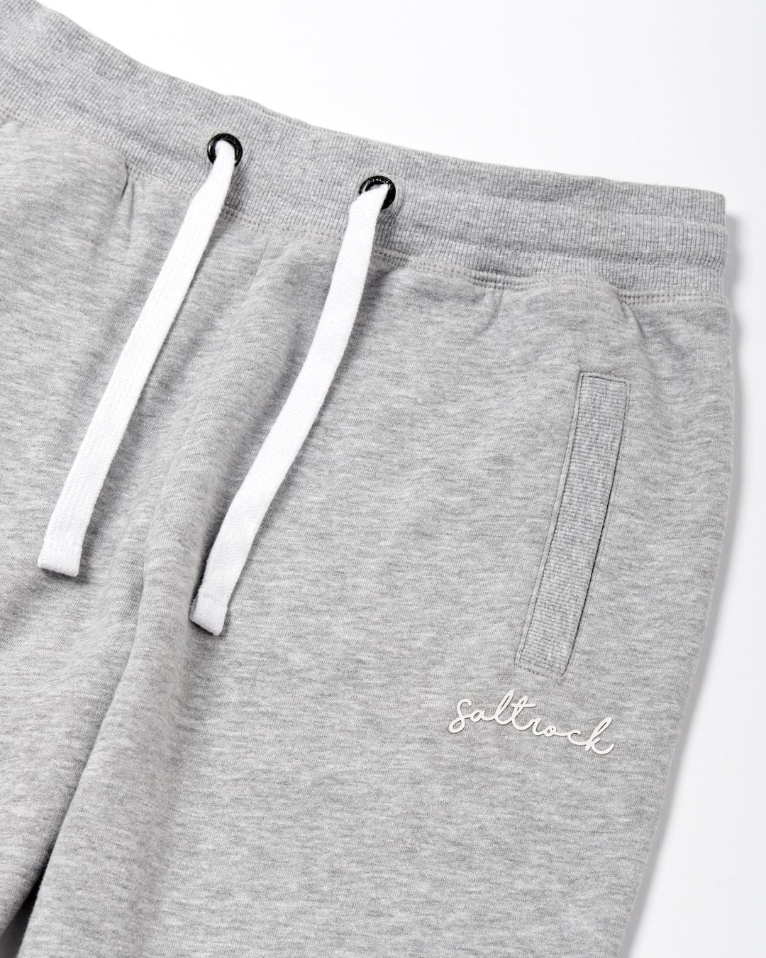 Women's elasticated waist joggers / sweatpants in light grey.