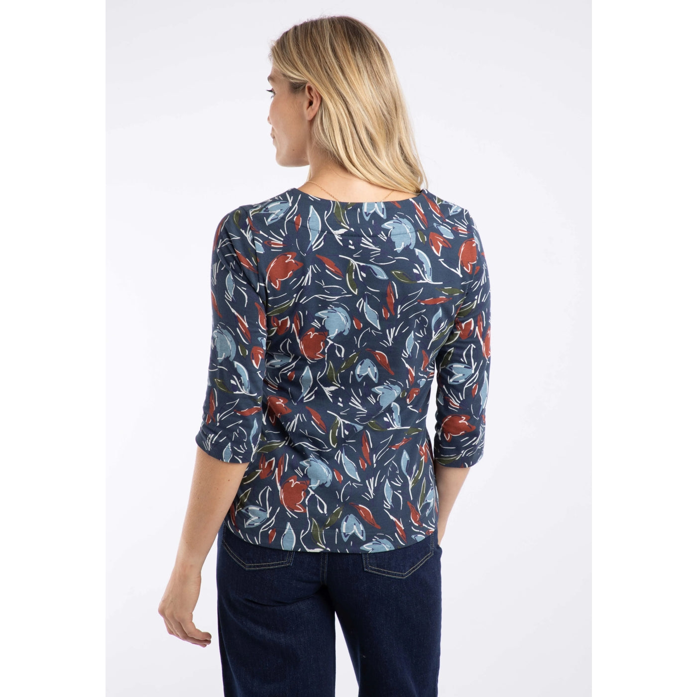 Woman wearing a Weird Fish floral patterned t-shirt on a white background