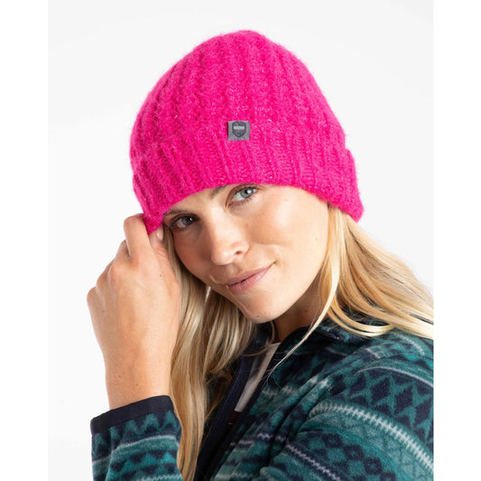 Woman wearing a bright pink Weird Fish Clare beanie with turn up hem and a brand logo on a white background