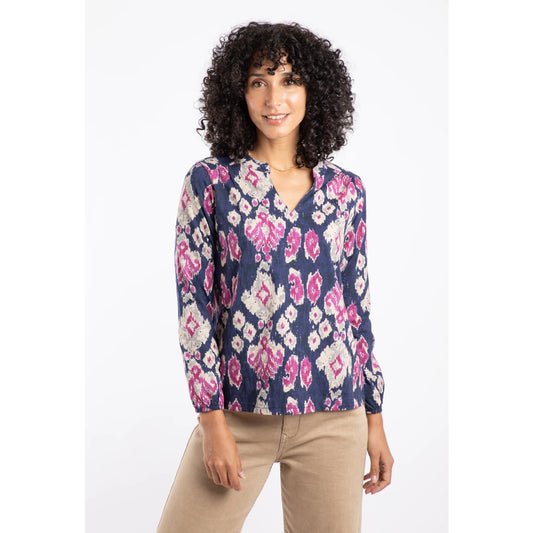 Woman wearing a Weird Fish abstract pattern blue and pink Brooke top with a white background
