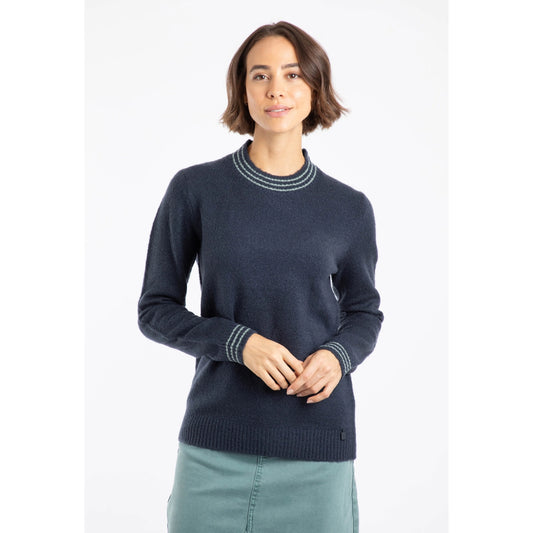 Front view of a woman wearing a navy Weird Fish knitted Dawkins jumper with turquoise line trim on a white background