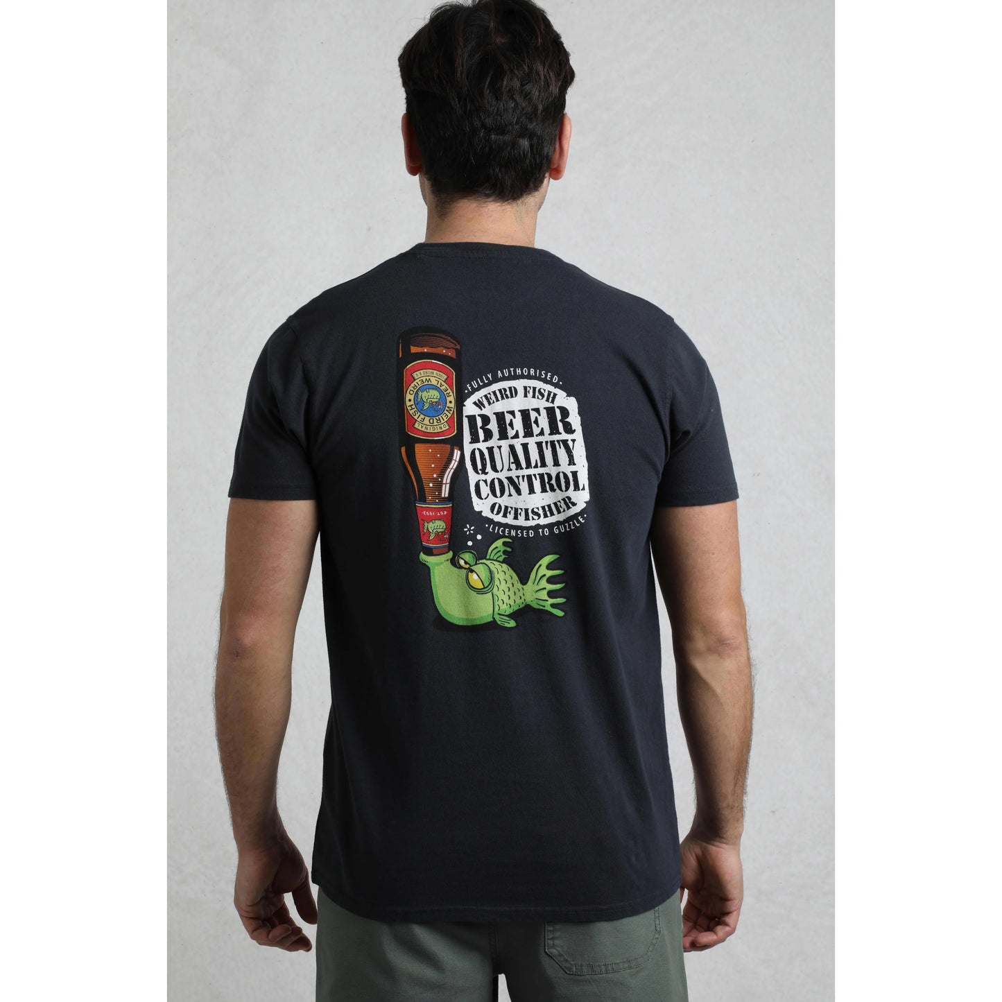 Person wearing a black t-shirt with a graphic design on the back, standing against a plain background.
