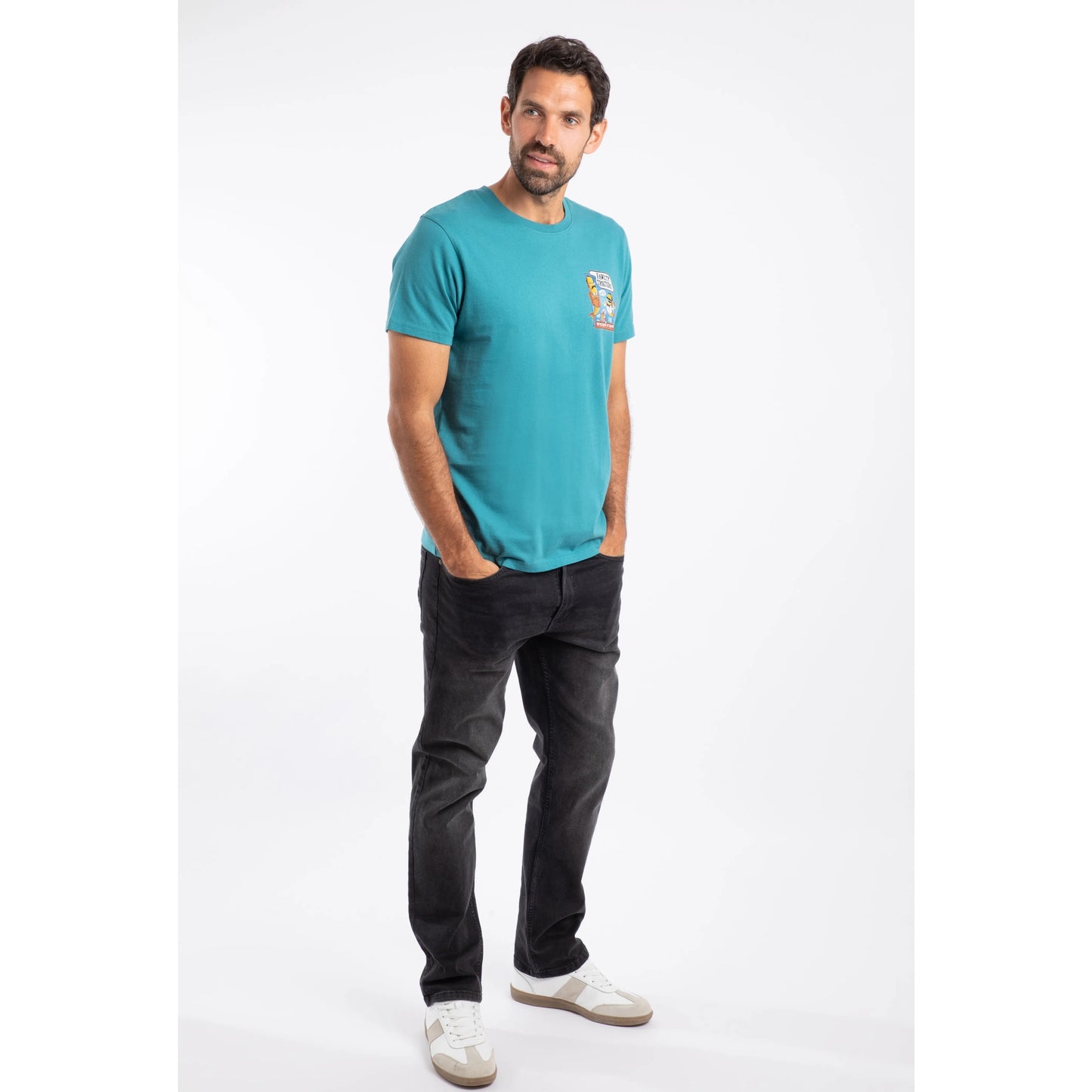 Man wearing Weird Fish mens Fawlty Trouters t-shirt Teal paired with black jeans and white sneakers