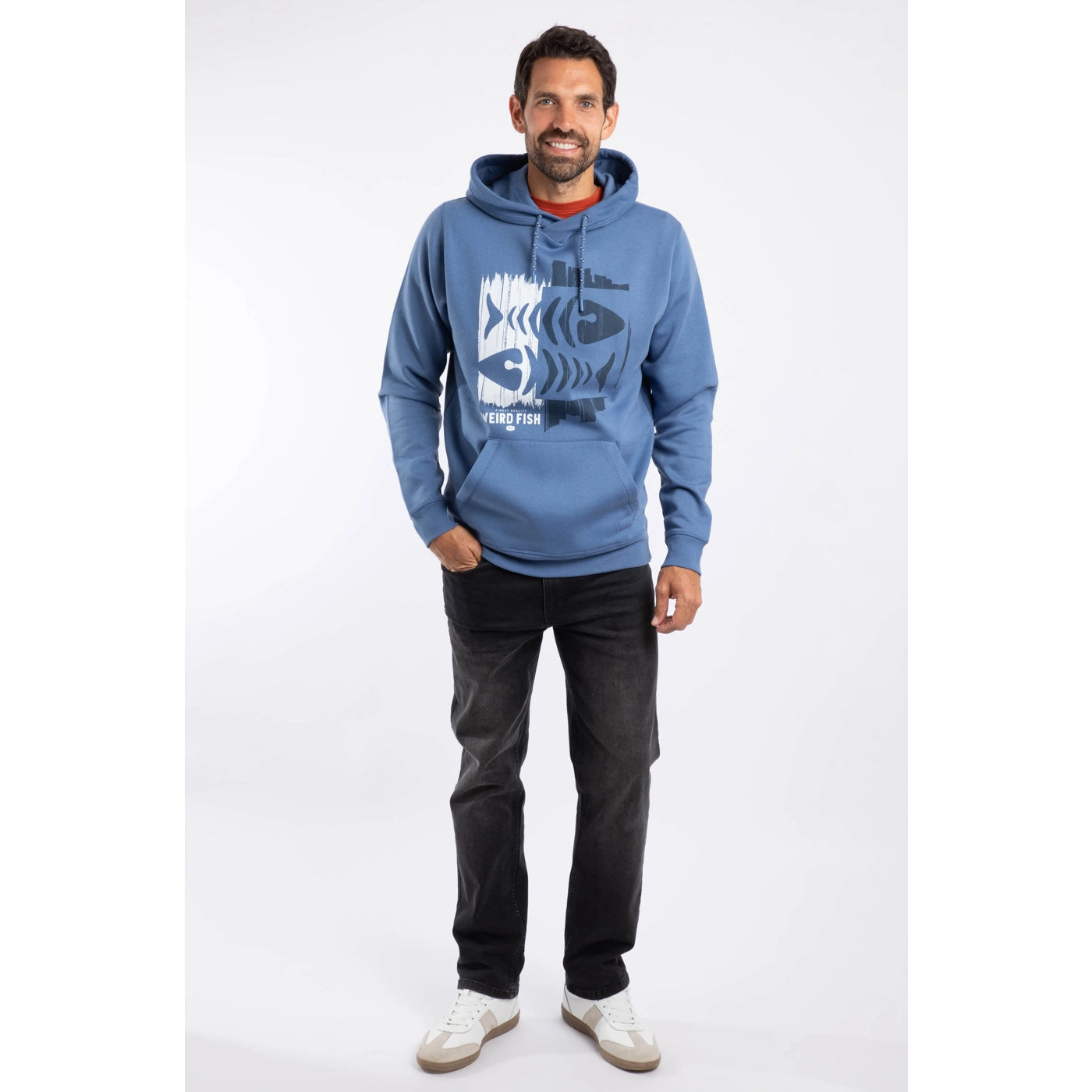 Man wearing a blue Weird Fish Bryant hoodie with a fishbones print design on a white background