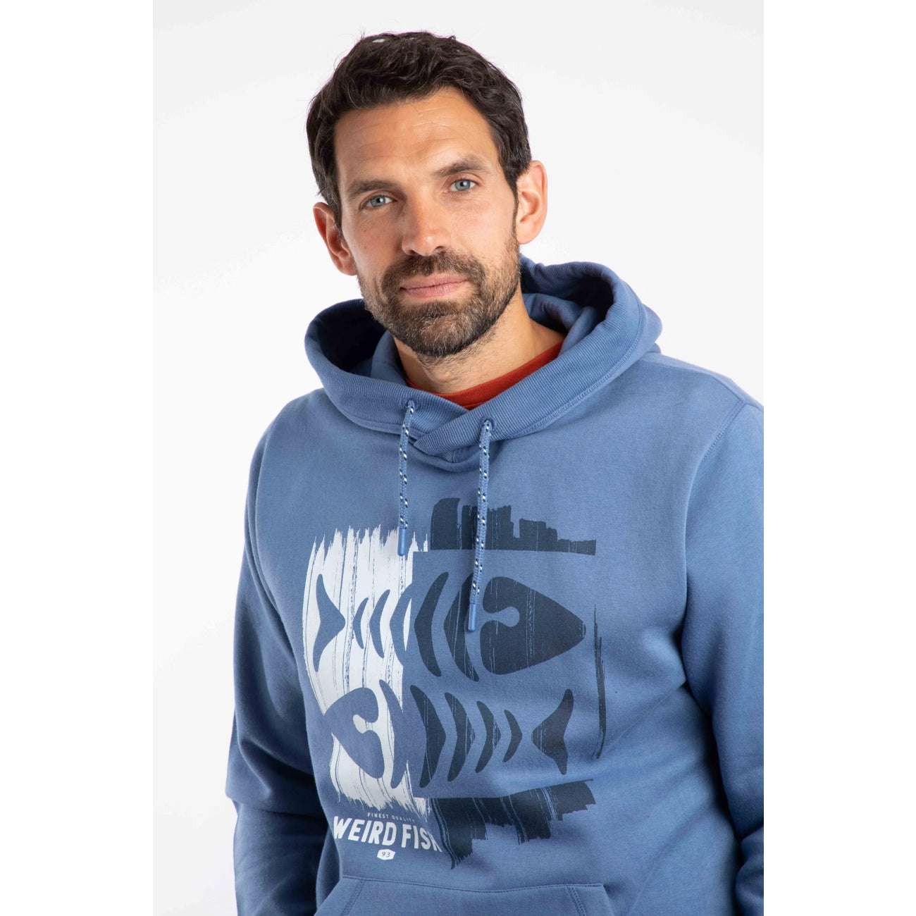 Man wearing a blue Weird Fish Bryant hoodie with a fishbones print on a white background