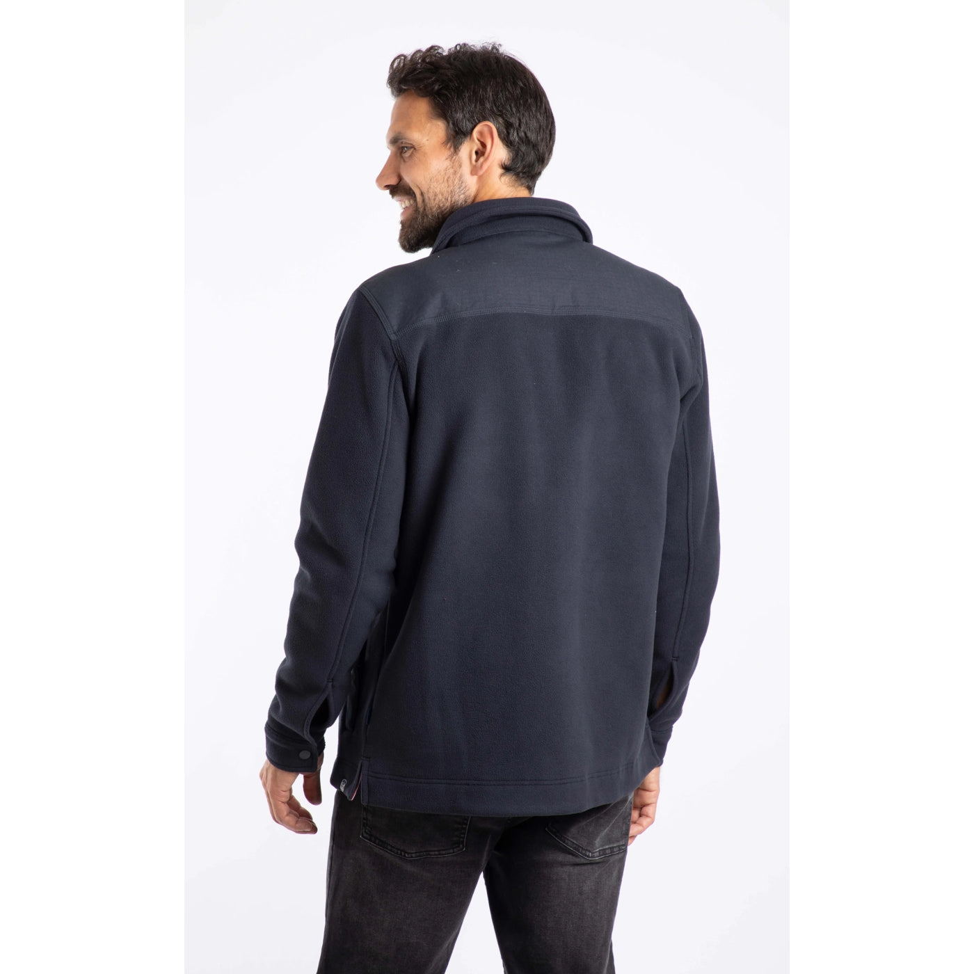 Back view of a man wearing a dark navy Weird Fish Boyd fleece jacket on a white background