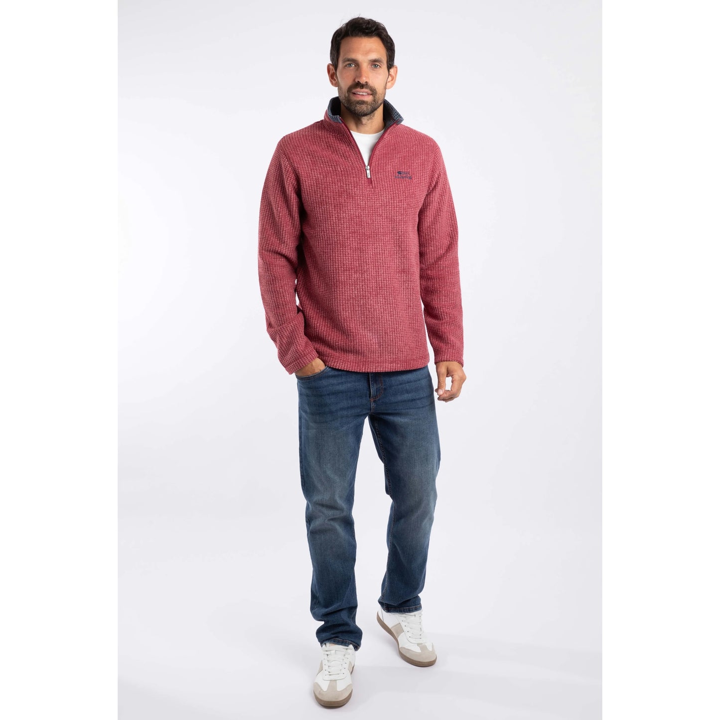 Weird Fish mens Newark grid fleece in Rhubarb red worn by man with blue jeans and white sneakers