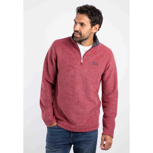 Front view of a Weird Fish mens Newark grid fleece in Rhubarb red quarter zip pullover worn by man