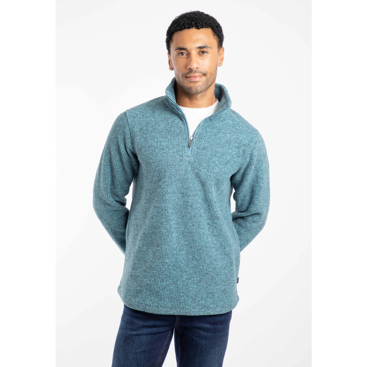 Front view of a man wearing a blue Weird Fish Newport fleece with a white background