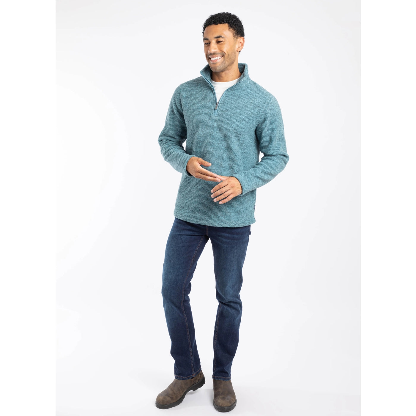 Man wearing a blue Weird Fish Newport fleece and dark jeans on a white background