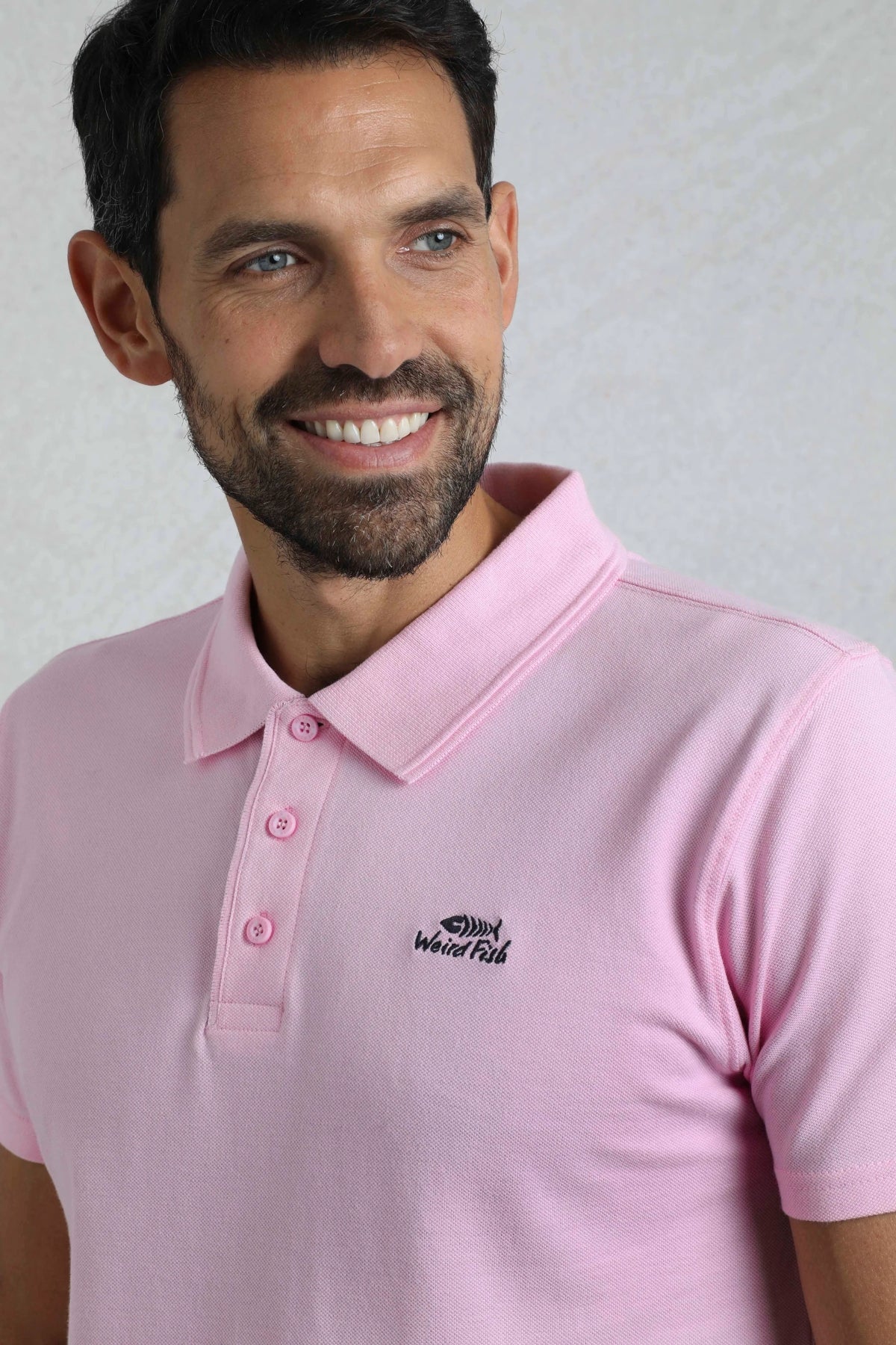 Weird Fish mens pink polo shirt with button-up collar and embroidered logo on chest