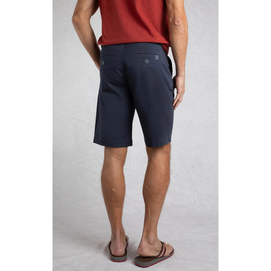 Back view of man wearing Weird Fish mens Rayburn navy chino shorts with buttoned back pockets