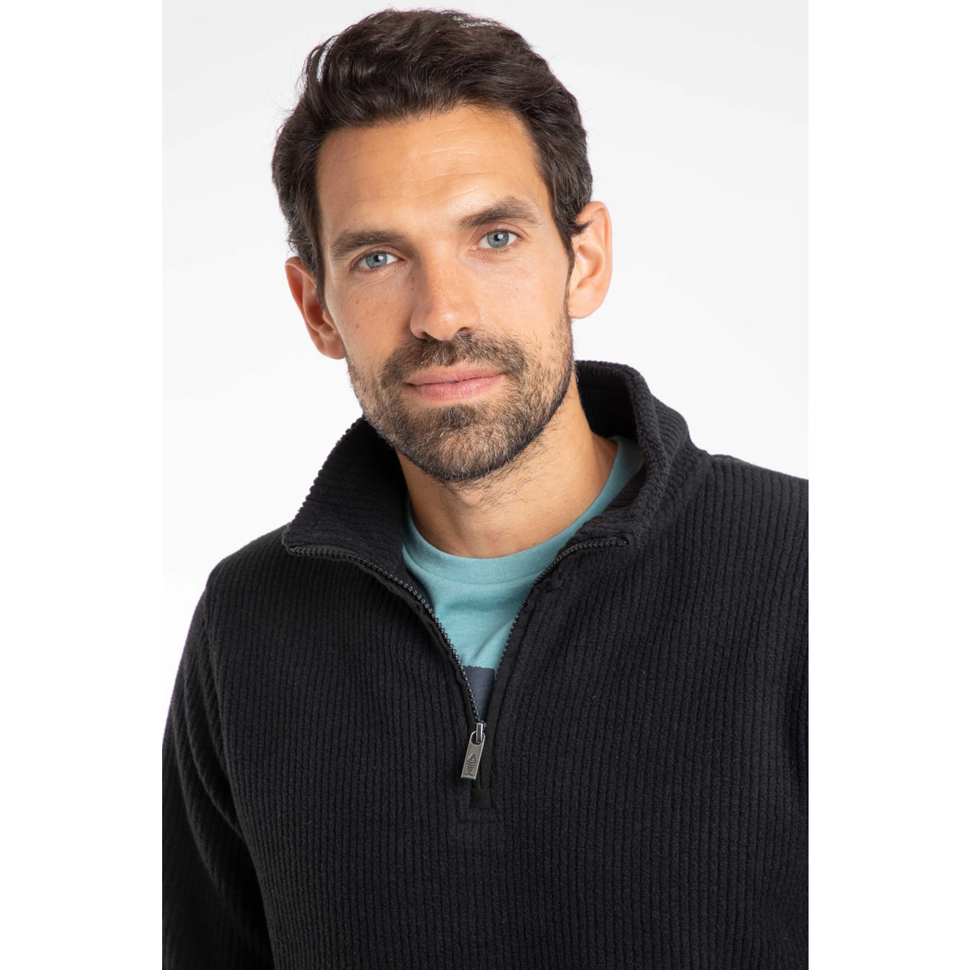 Man wearing a black Weird Fish 1/4 zip fleece over a light blue shirt on a white background