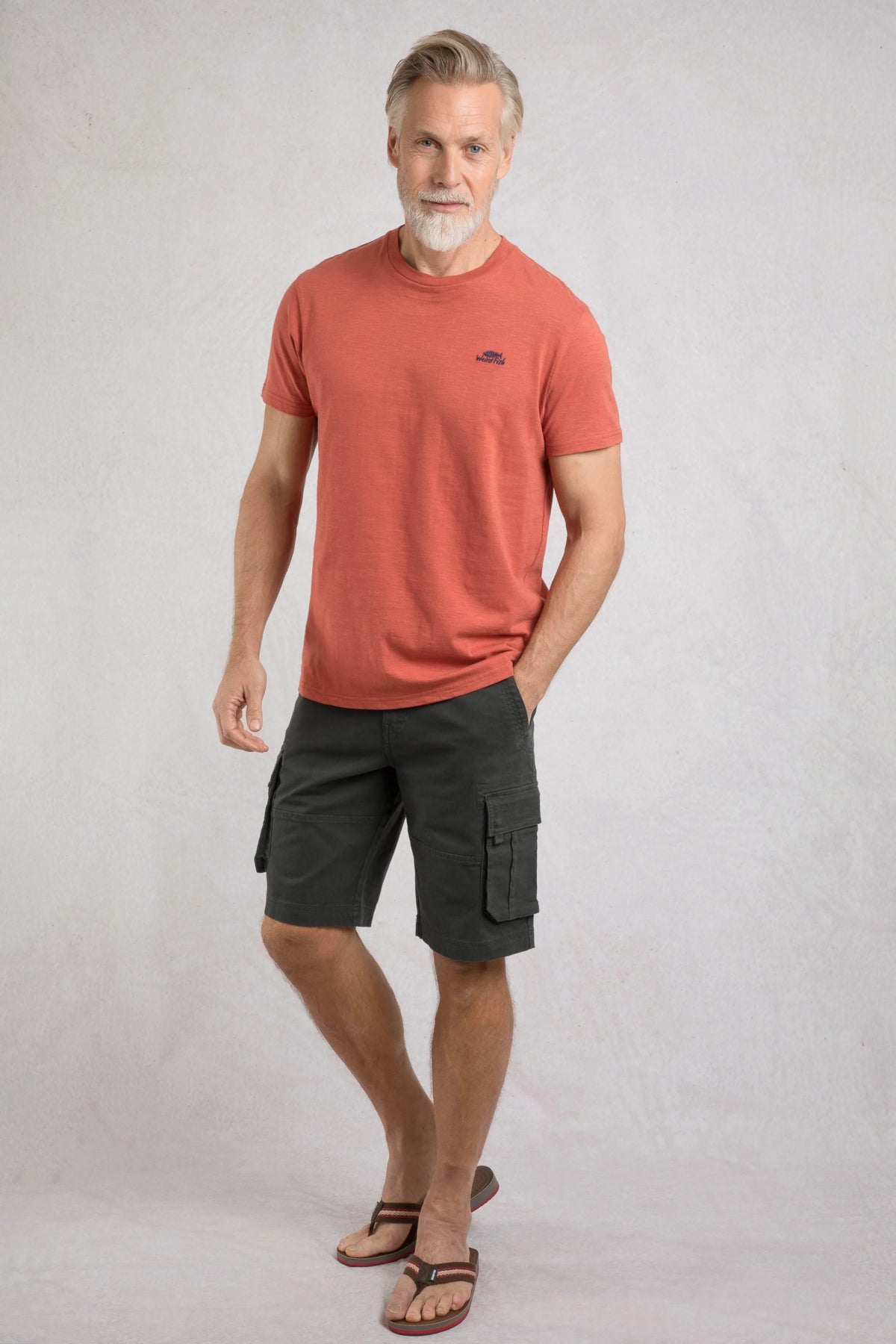Weird Fish mens t-shirt baked clay color worn by man with gray hair paired with black cargo shorts