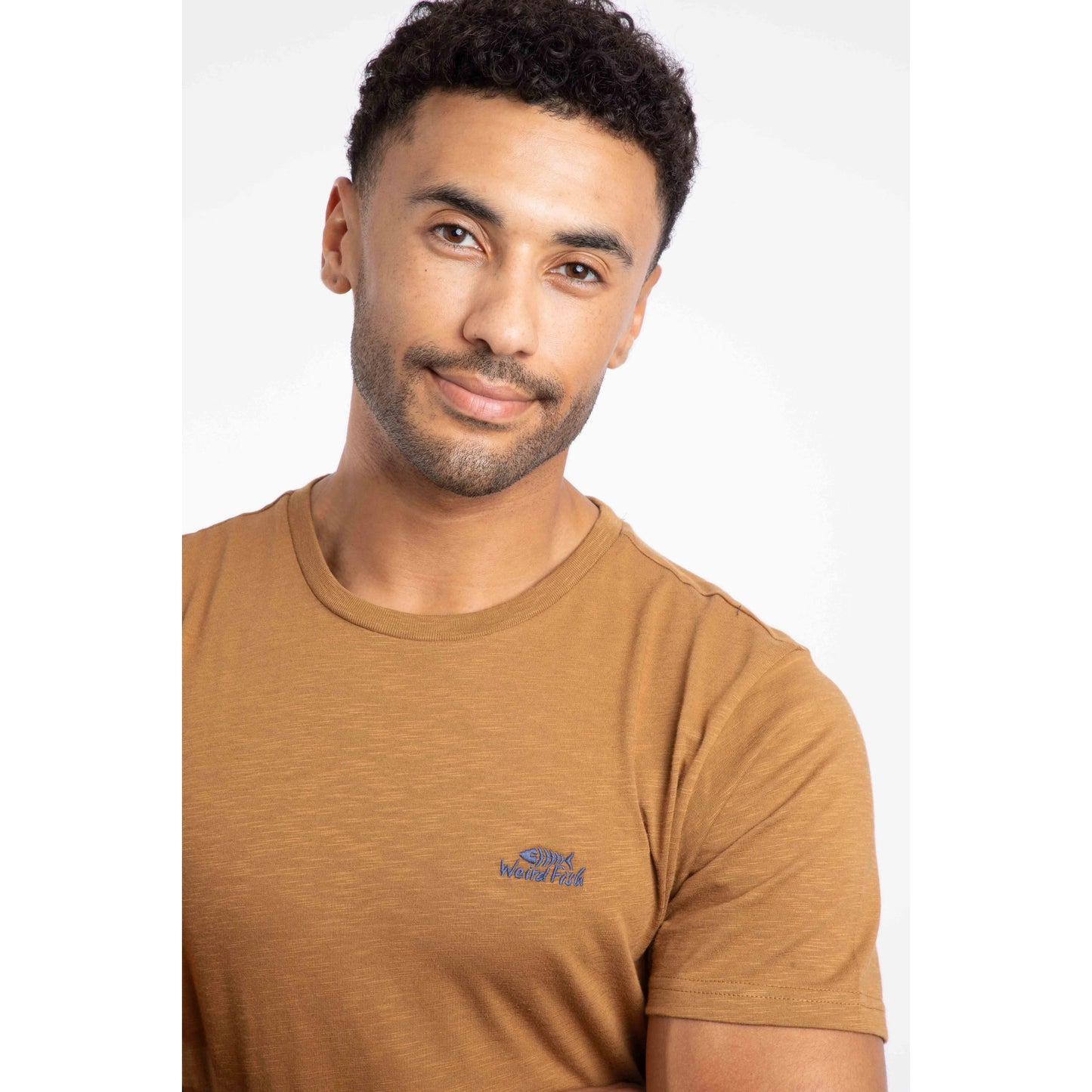 Weird Fish mens t-shirt Fox brown with crew neck and small logo on chest worn by man