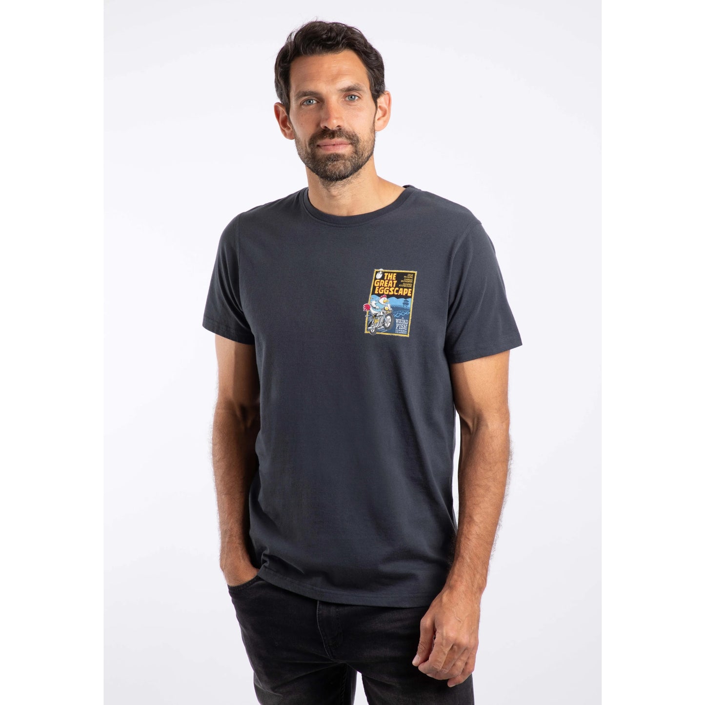 Man wearing a navy t-shirt with a graphic design on a white background