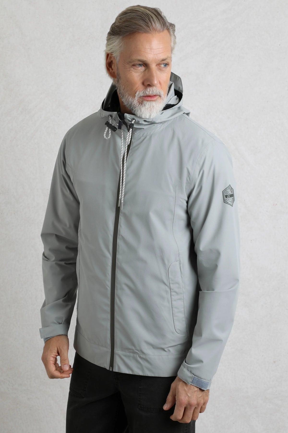 Weird Fish mens waterproof jacket grey with hood and full zip closure worn by male model