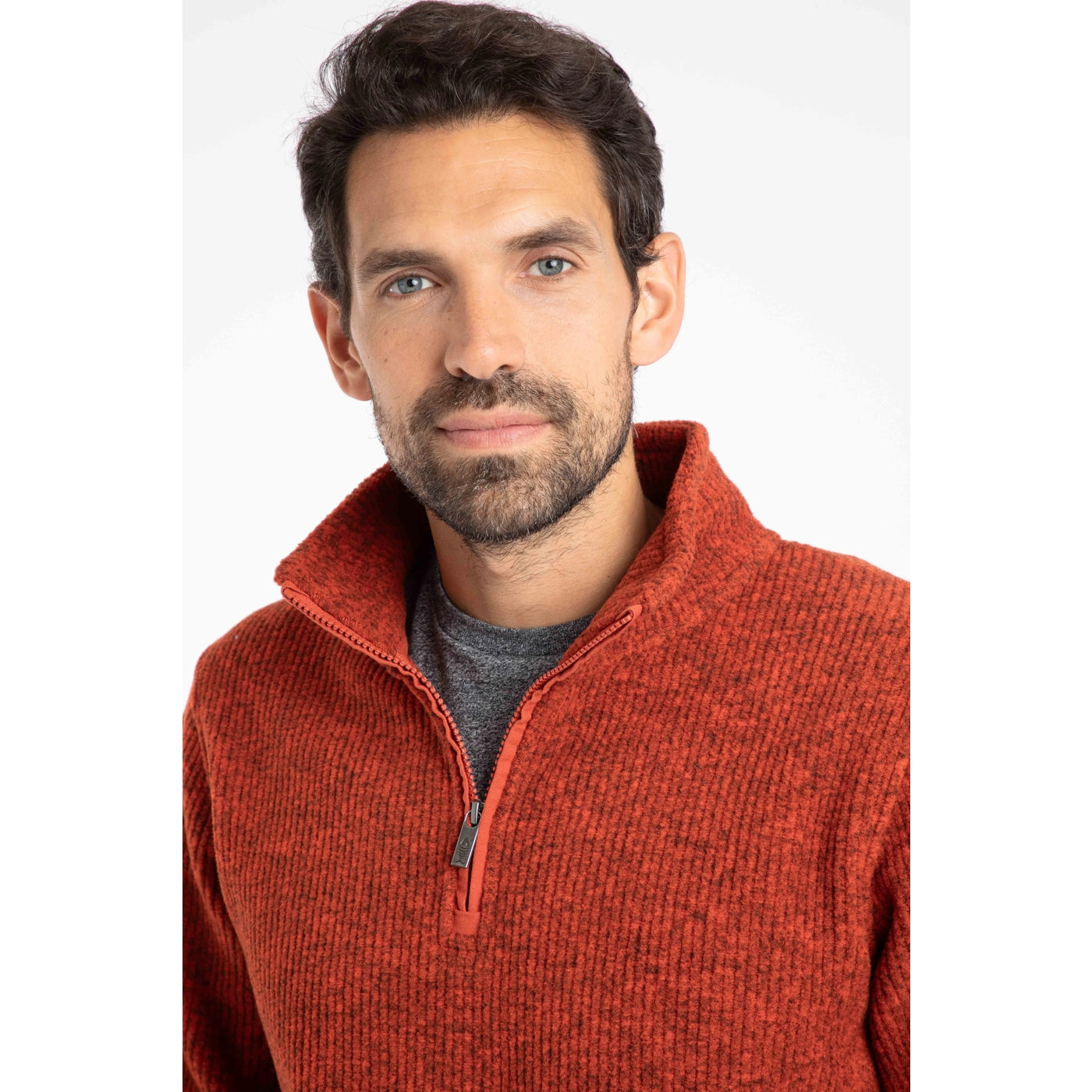 Man wearing a Weird Fish rust red Newport fleece with a white background