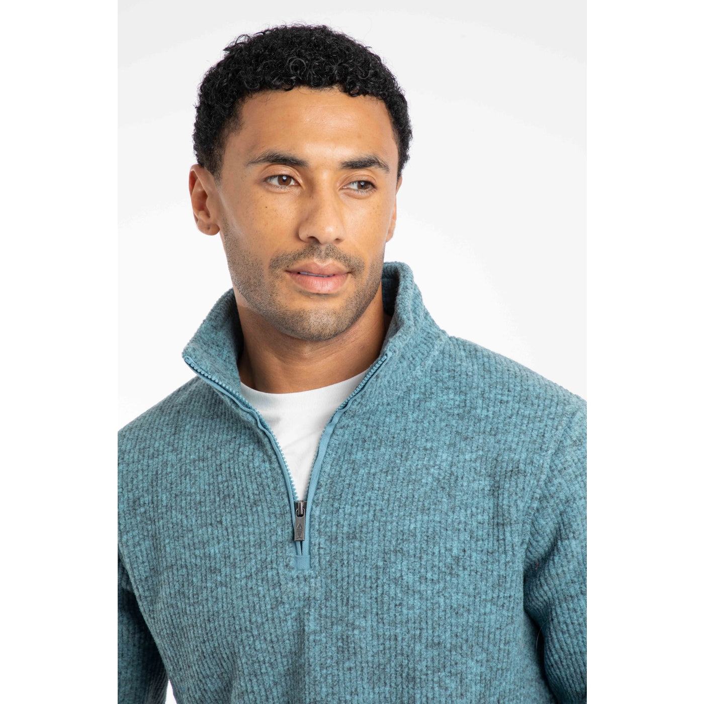 Man wearing a Weird Fish blue half-zip fleece on a white background