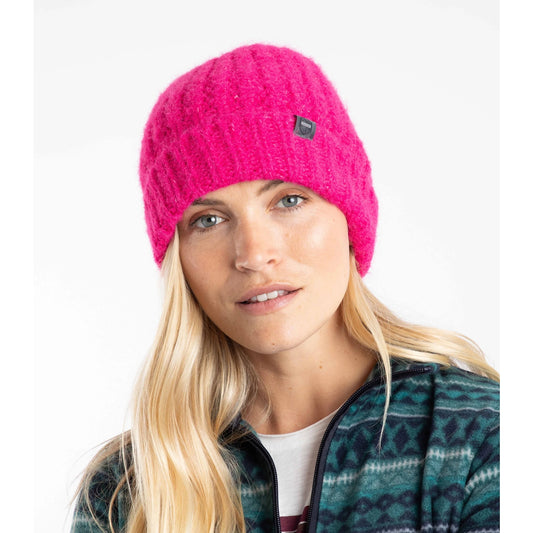 Woman wearing a bright fuchsia pink Weird Fish Clare double rib knit beanie with turn up hem on a white background